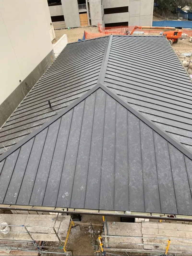 Commercial metal roof construction with crane equipment in Lake Station